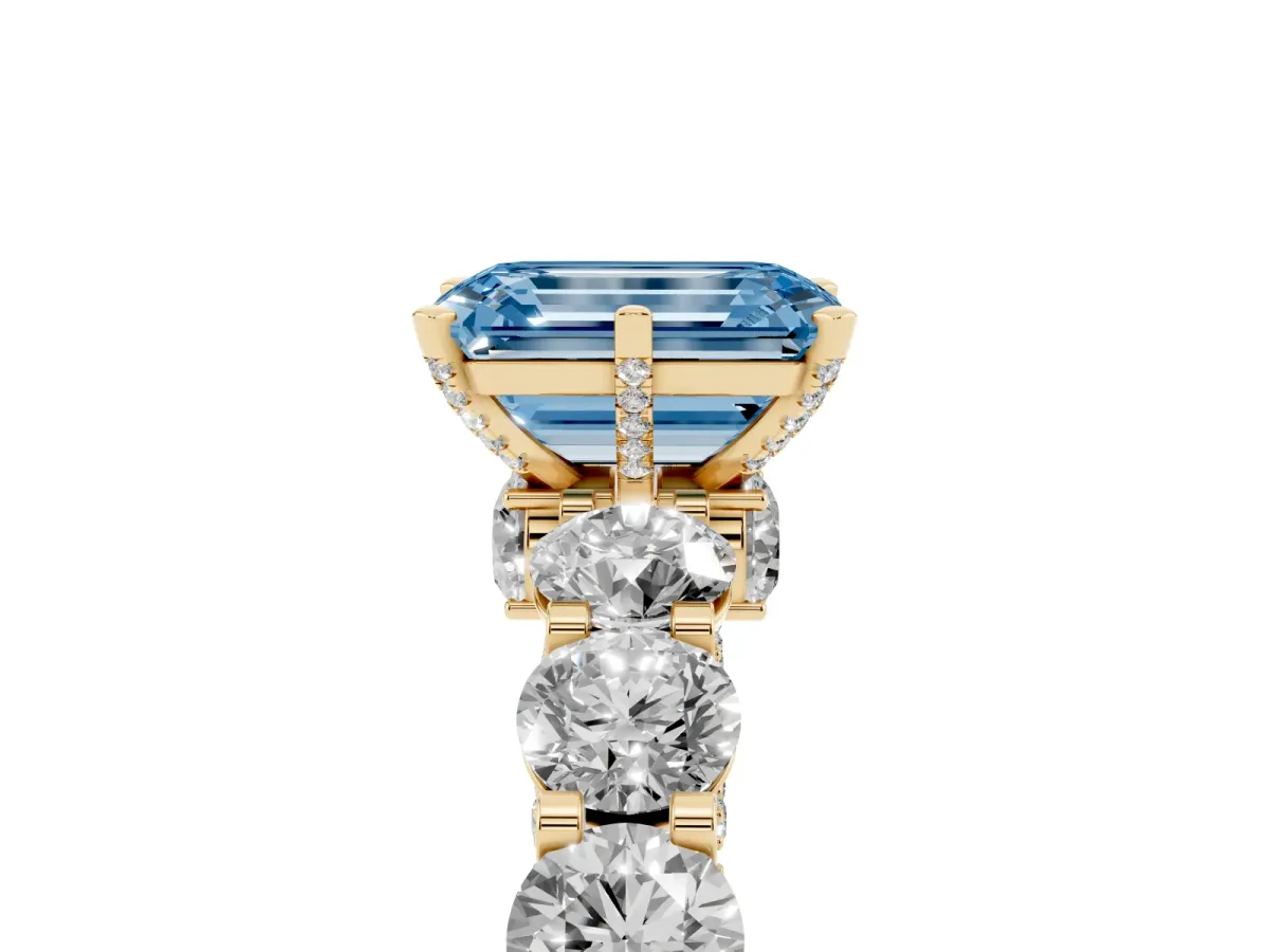 Fancy Blue Emerald Cut Diamond Side Stone Engagement Ring with Four-Prong Setting Yellow gold