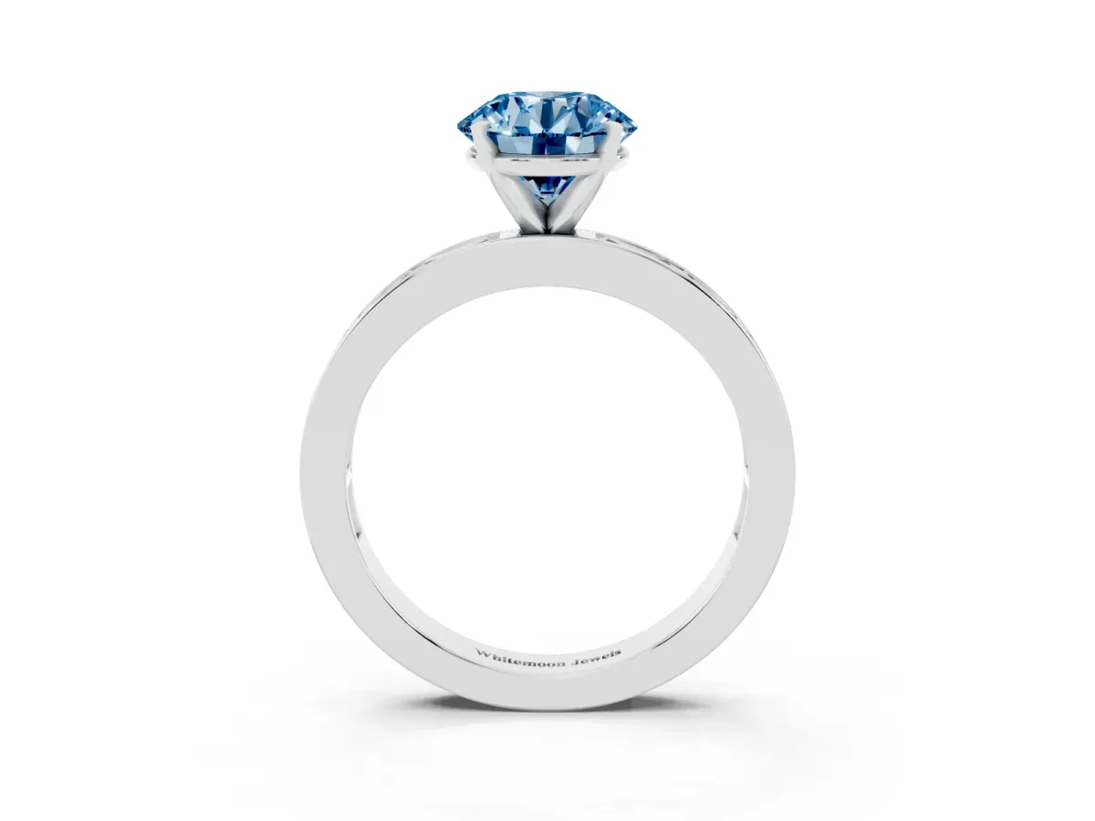Fancy Blue Round Cut Solitaire Diamond Ring with Channel-Set Baguette Band and Four-Prong Setting White gold