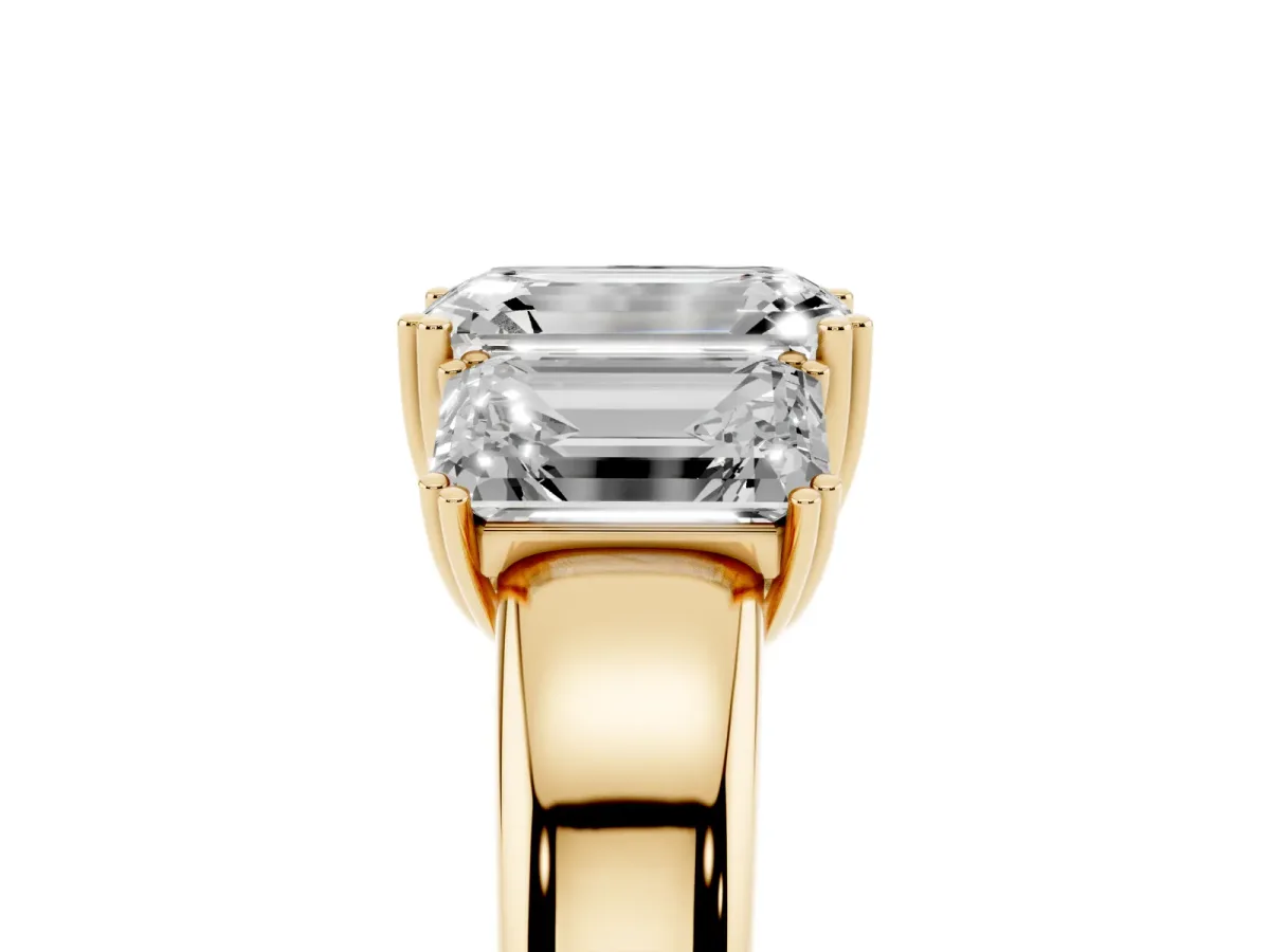 Three-Stone Emerald Cut Cut Diamond Ring with Channel Set Band and Four-Prong Setting Yellow gold