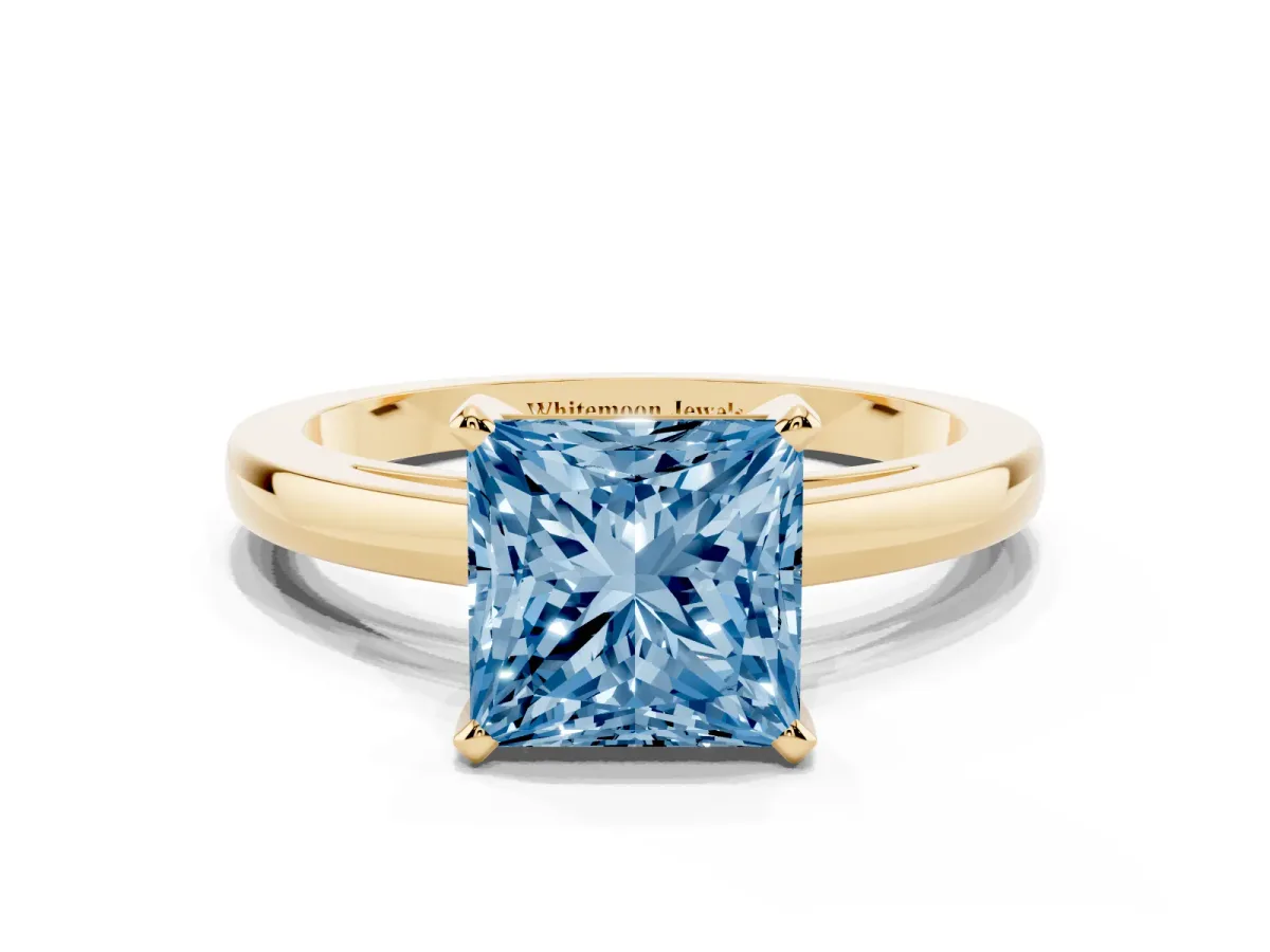 Fancy Blue Princess Cut Solitaire Diamond Engagement Ring with Four-Prong Setting on a Classic Band Yellow gold