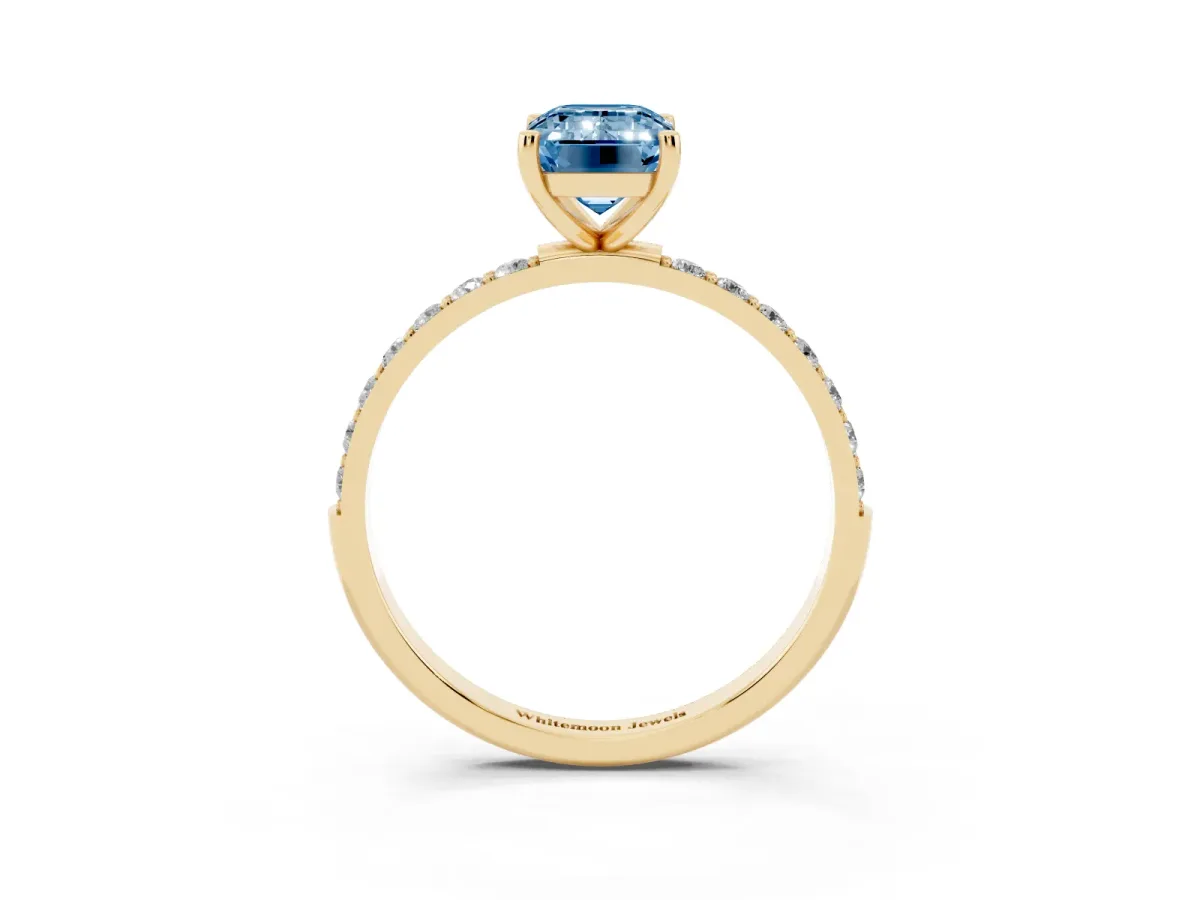 Fancy Blue Emerald Cut Diamond Solitaire Ring with Round Pavé Shoulders and Prong Setting Yellow gold