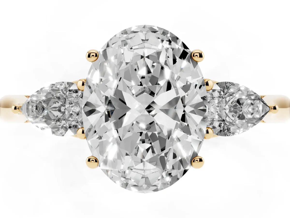 Three-Stone Oval Cut Brilliant Diamond Solitaire Ring with Tapered Band and Four-Prong Setting Yellow gold