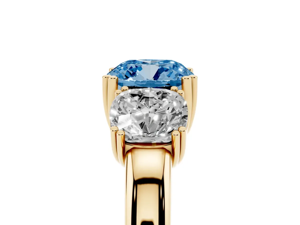 Fancy Blue Three-Stone Cushion Cut Cut Diamond Ring with Channel Set Band and Four-Prong Setting Yellow gold
