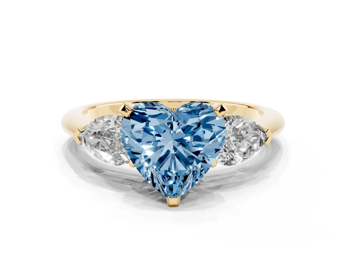 Fancy Blue Three-Stone Heart Cut Diamond Ring with Pear Side Stones and Four-Prong Setting Yellow gold