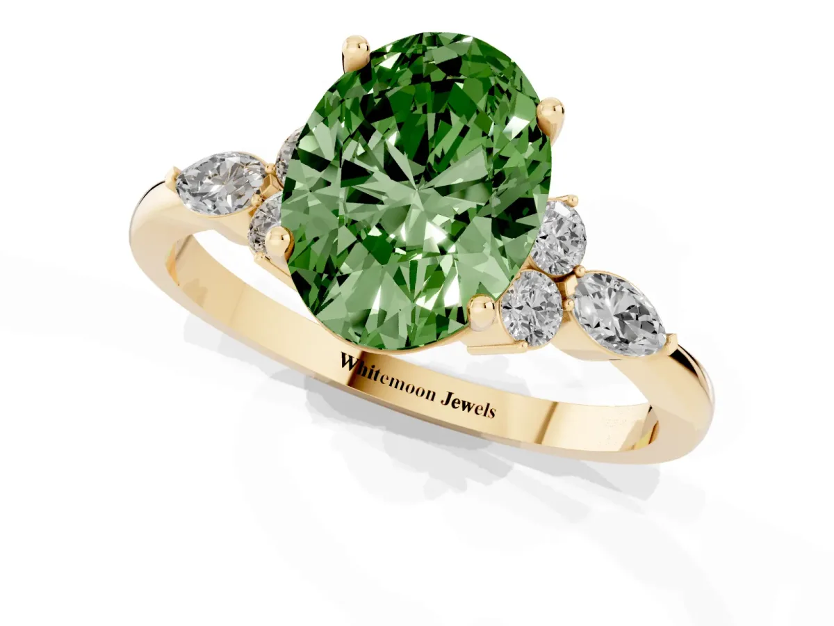 Fancy Green Oval Cut Brilliant Diamond Solitaire Ring with Pear Side Stones and Four-Prong Setting Yellow gold