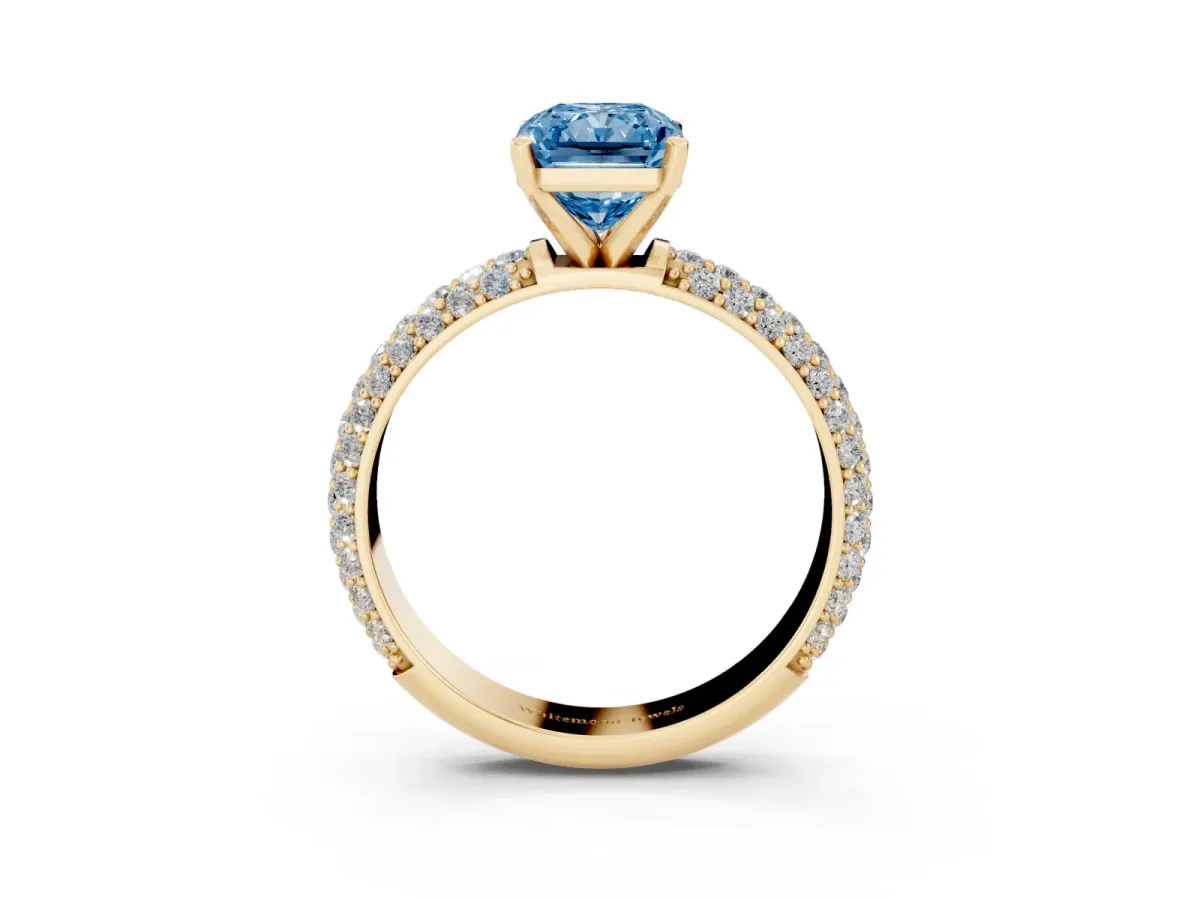 Fancy Blue Radiant Cut Diamond Solitaire Ring with Prong Setting and Pavé Band Yellow gold