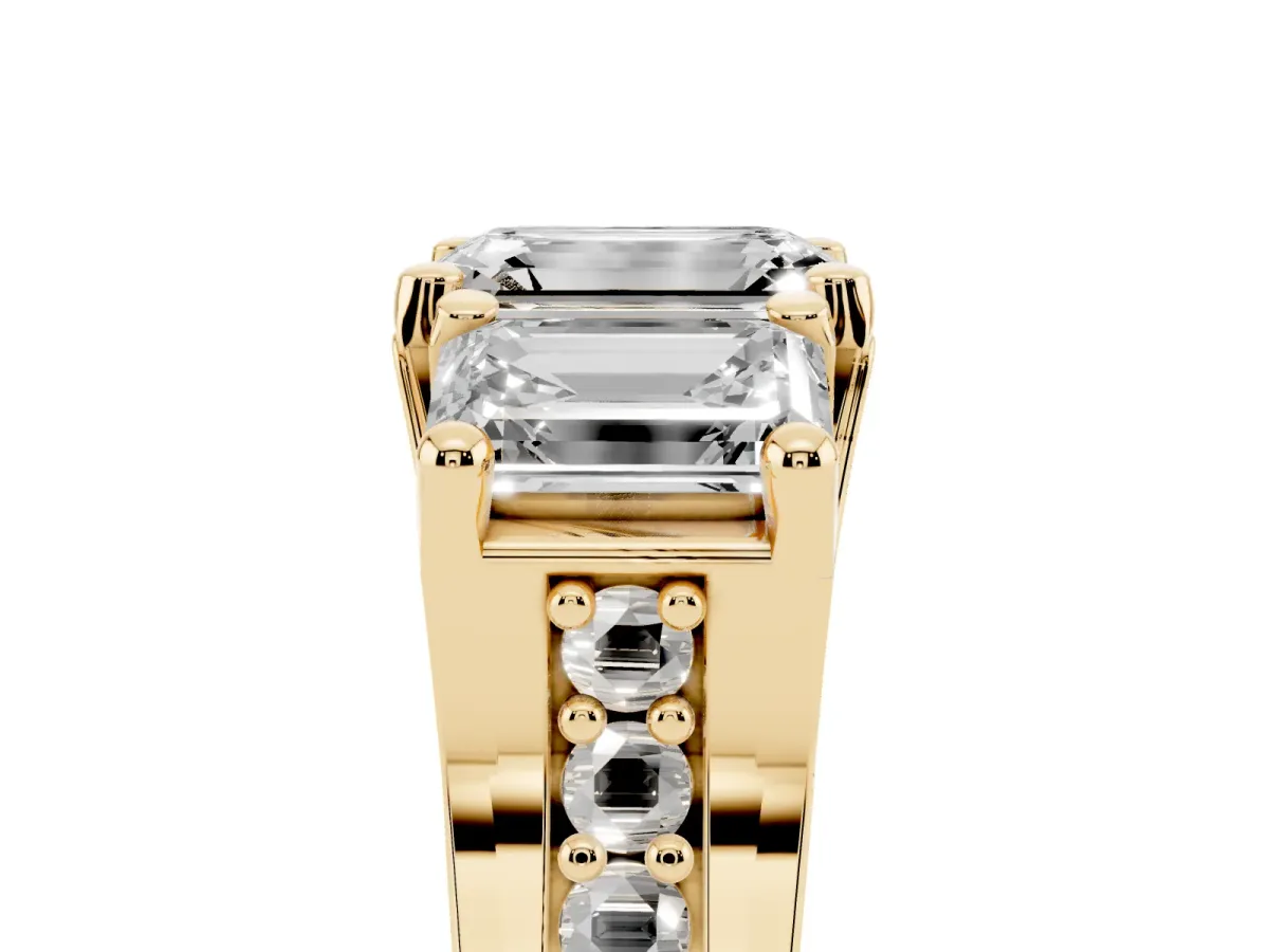 Emerald Cut Diamond Three-Stone Ring with Channel Set Band and Four-Prong Setting Yellow gold