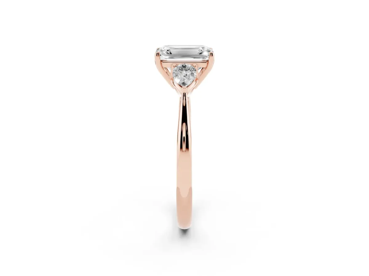 Three-Stone Emerald Cut Diamond Ring with Pear Side Stones in Four-Prong Setting Rose gold