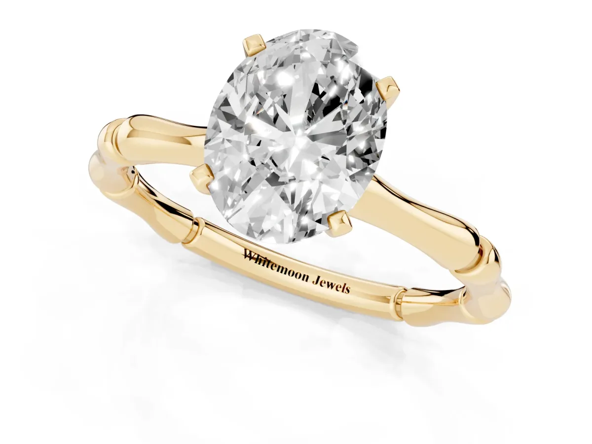 Oval Cut Solitaire Diamond Ring with Bamboo Band and Four-Prong Setting Yellow gold