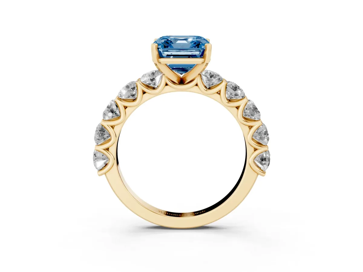 Fancy Blue Asscher Cut Diamond Prong Setting with Side Stones on a Pave Band Yellow gold