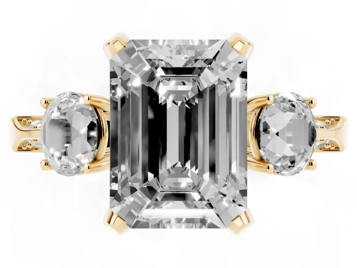 Emerald Cut Brilliant Three-Stone Diamond Ring with Pavé Band and Four-Prong Setting Yellow gold