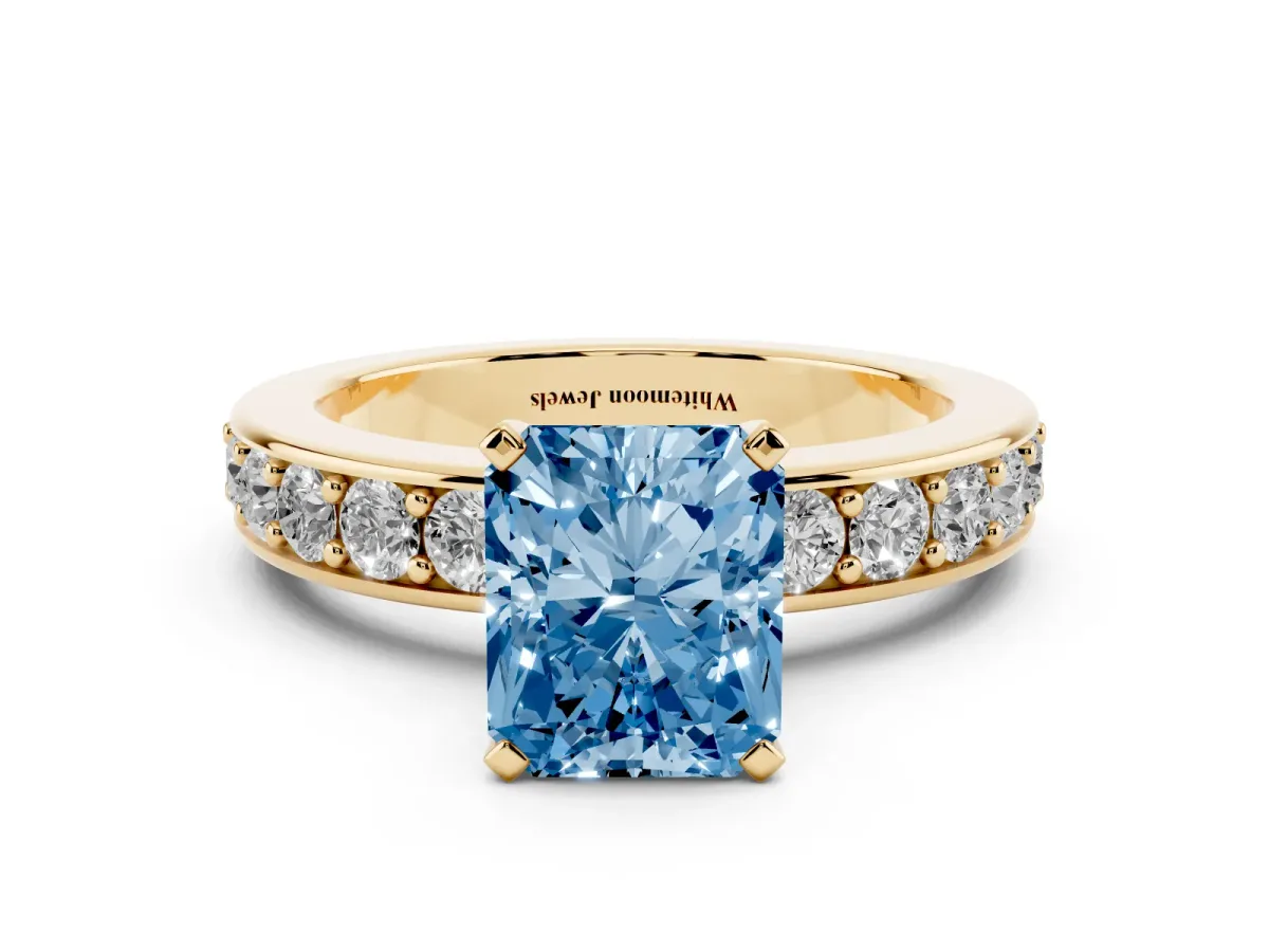 Fancy Blue Radiant Cut Diamond Engagement Ring with Channel Set Round Band and Prong Setting Yellow gold
