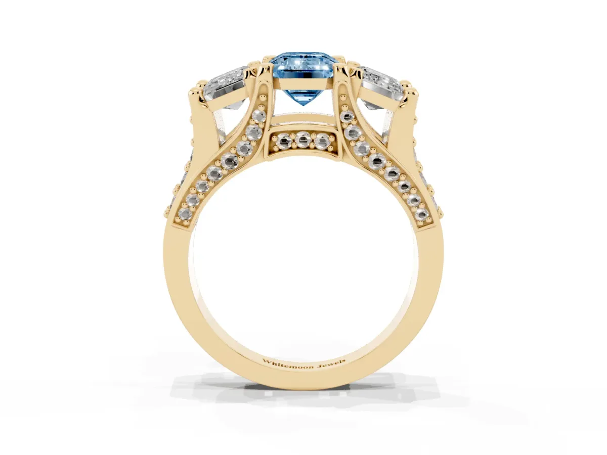 Fancy Blue Emerald Cut Diamond Three-Stone Ring with Channel Set Band and Four-Prong Setting Yellow gold