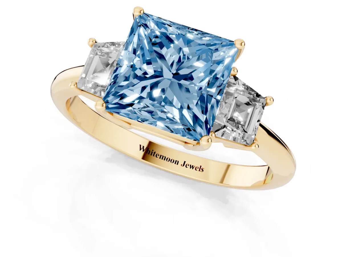 Fancy Blue Princess Cut Diamond Three-Stone Ring with Trapezoid Side Stones and Prong Setting Yellow gold
