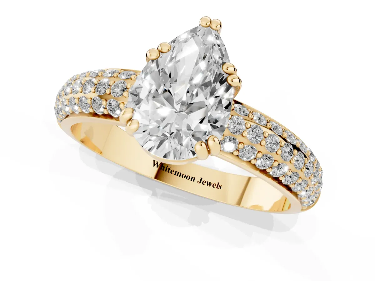 Pear Cut Diamond Solitaire Ring with Multi-Row Round Pavé Band and Prong Setting Yellow gold