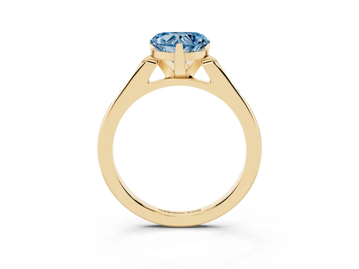 Fancy Blue Heart Cut Diamond Solitaire Ring with Channel Set Round Band and Prong Setting Yellow gold