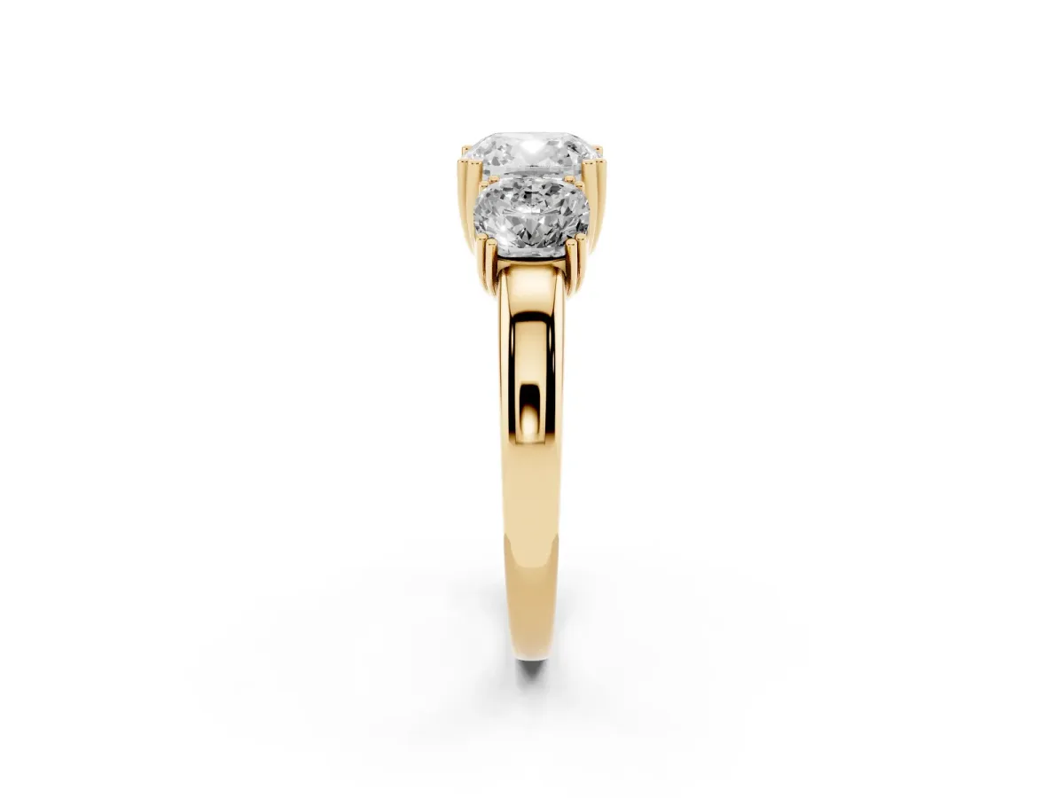 Three-Stone Cushion Cut Cut Diamond Ring with Channel Set Band and Four-Prong Setting Yellow gold