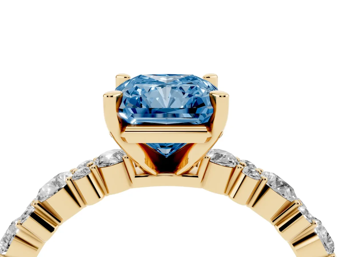 Fancy Blue Radiant Cut Diamond Side Stone Solitaire Ring with Round and Four-Prong Setting Yellow gold