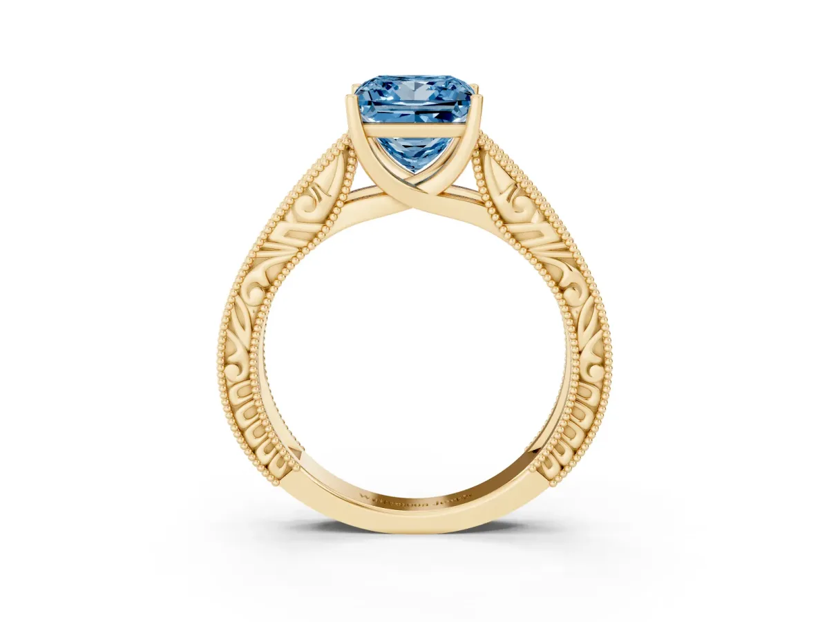 Fancy Blue Princess Cut Diamond Solitaire Ring with Engraved Band and Four-Prong Setting Yellow gold