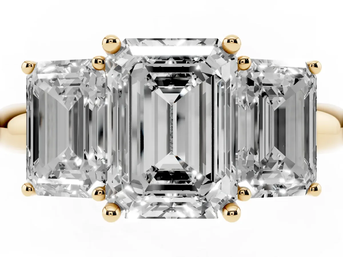 Three-Stone Emerald Cut Cut Diamond Engagement Ring with Prong Setting on a White Gold Band Yellow gold