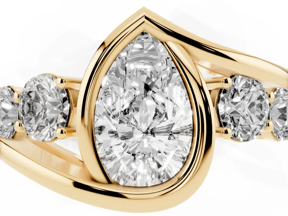 Bezel Set Pear Cut Diamond Bypass Ring with Round Accents Yellow gold