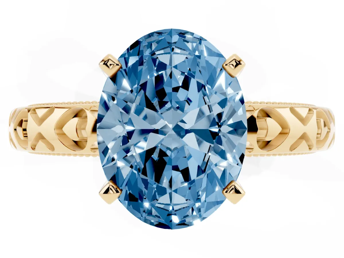 Fancy Blue Oval Cut Solitaire Diamond Engagement Ring with XO Engraved Band and Four-Prong Setting Yellow gold