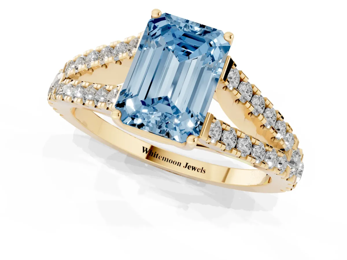 Fancy Blue Emerald Cut Diamond Split Shank Engagement Ring with Round Pavé and Prong Setting Yellow gold
