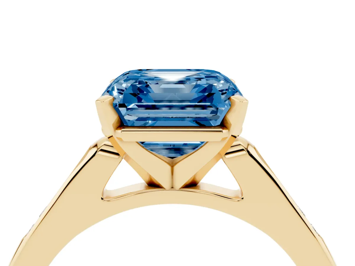 Fancy Blue Asscher Cut Diamond Solitaire Ring with Channel Set Round Band and Prong Setting Yellow gold