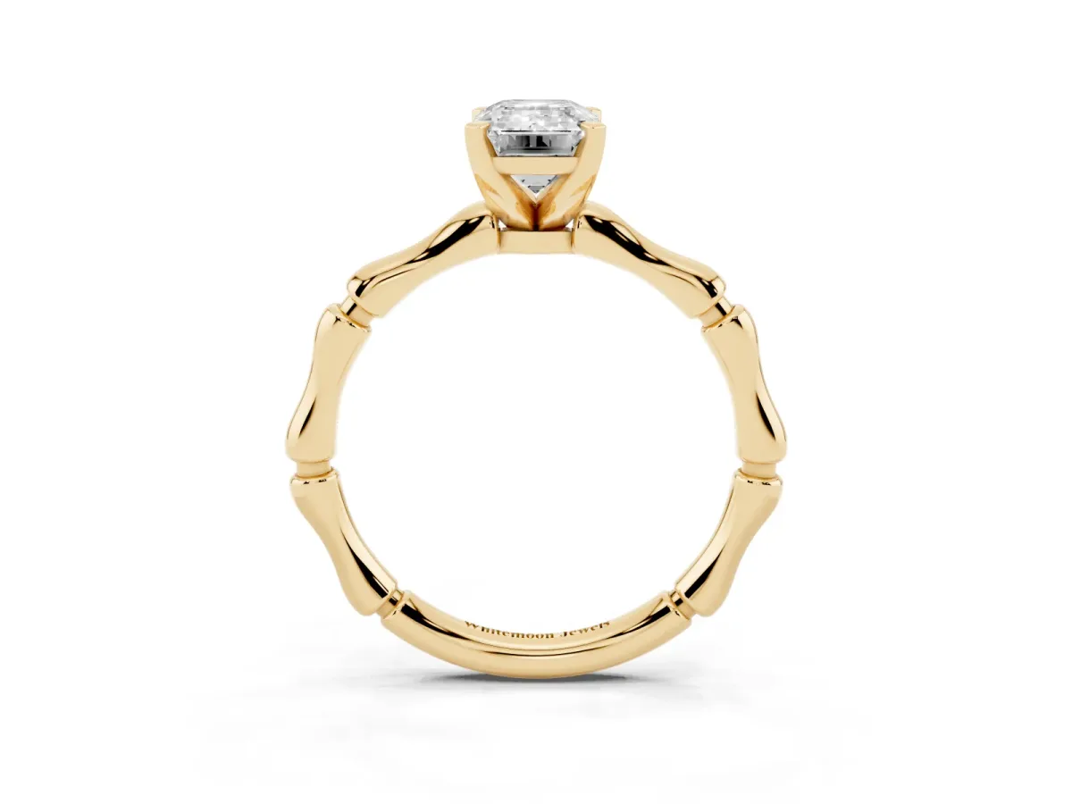 Emerald Cut Solitaire Diamond Ring with Bamboo Band and Four-Prong Setting Yellow gold