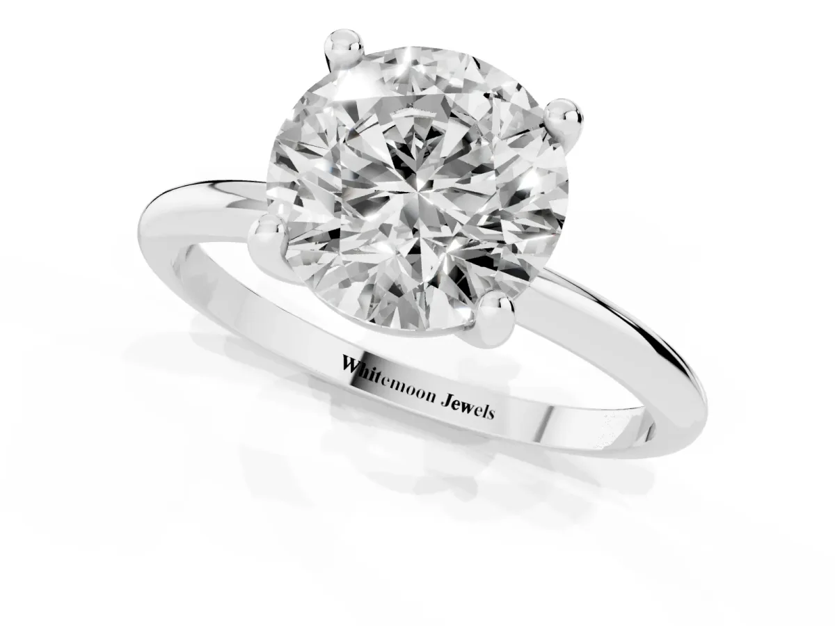 Round Cut Solitaire Diamond Ring with 4-Prong Setting on a Classic Band Platinum