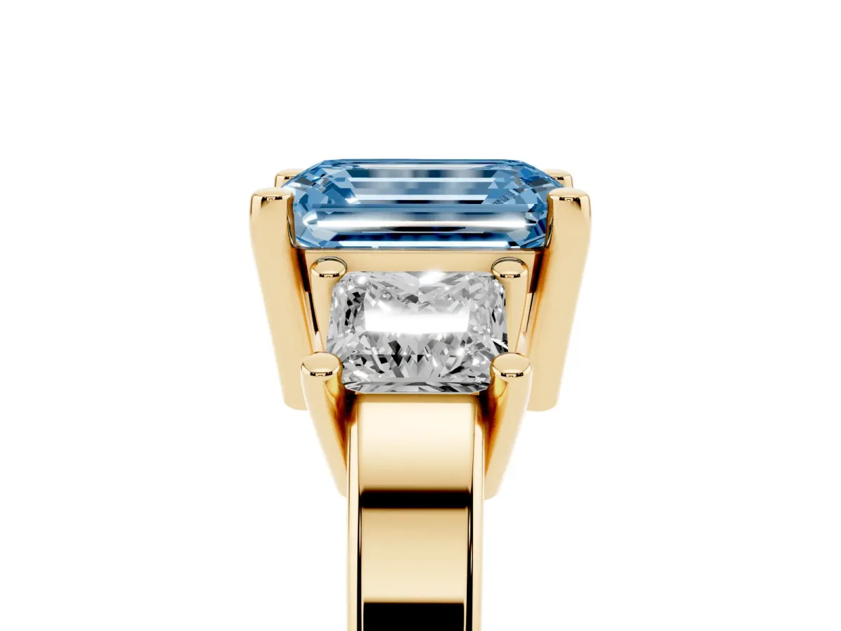 Fancy Blue Three-Stone Emerald Cut Cut Solitaire Ring with Prong Setting Yellow gold