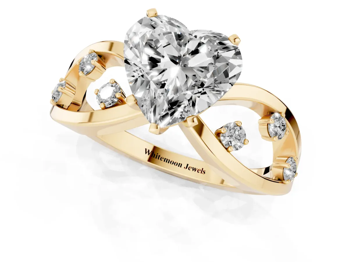 Heart Cut Cut Solitaire Diamond with Side Stones on Criss-Cross Band and Four-Prong Setting Yellow gold