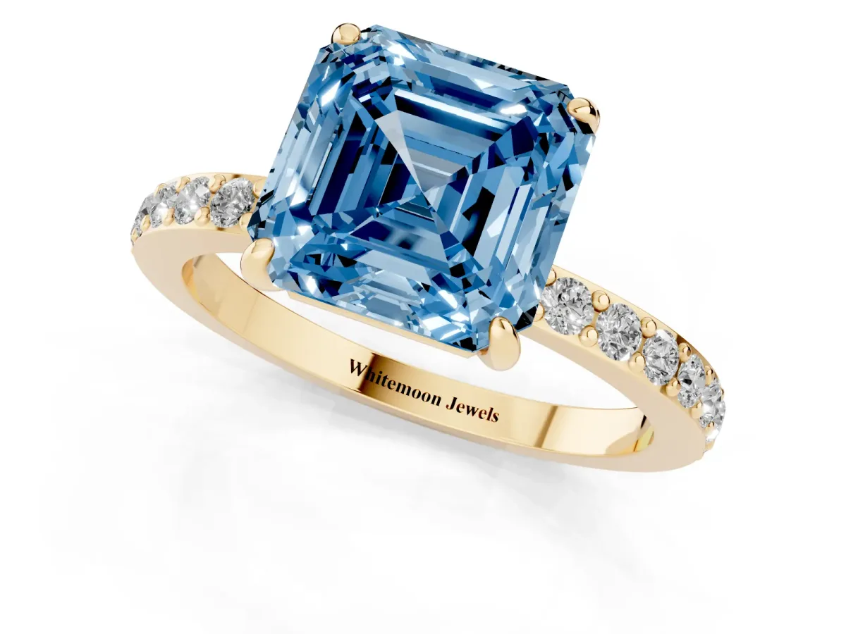 Fancy Blue Asscher Cut Diamond Pavé Engagement Ring with Round Accents and Prong Setting Yellow gold
