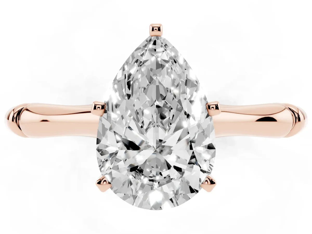 Pear Cut Solitaire Diamond Ring with Bamboo Band and Four-Prong Setting Rose gold