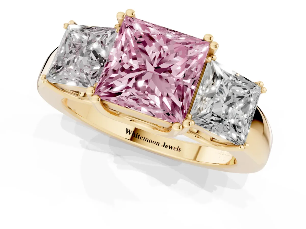 Fancy Pink Three-Stone Princess Cut Cut Diamond Ring with Channel Set Band and Four-Prong Setting Yellow gold