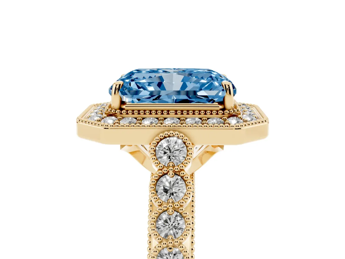 Fancy Blue Radiant Cut Halo Milgrain Solitaire with Bezel Set Side Stones and Pave Band Yellow gold