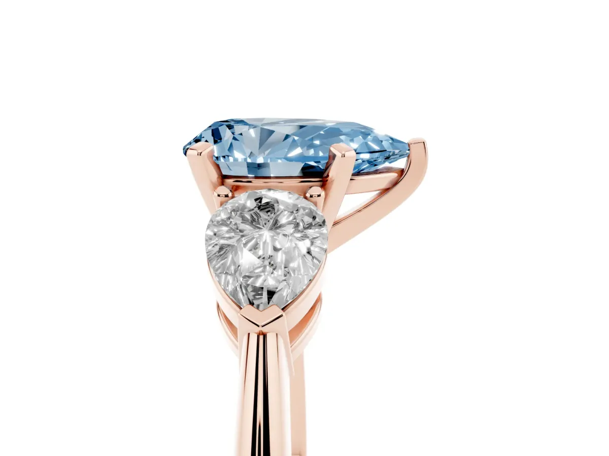 Fancy Blue Three-Stone Pear Cut Diamond Ring with Pear Side Stones and Four-Prong Setting Rose gold