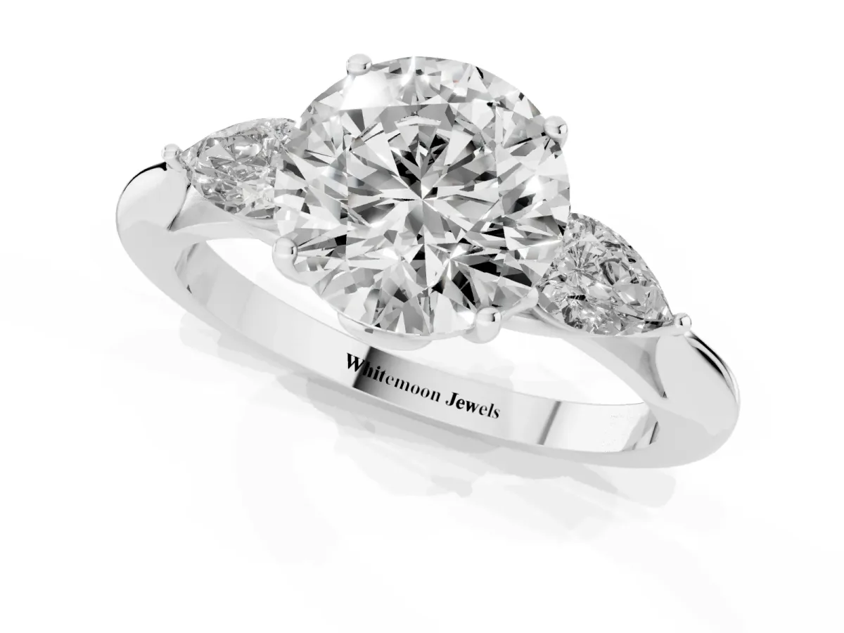 Round Cut Diamond Three-Stone Ring with Pear Side Stones and Prong Setting Platinum
