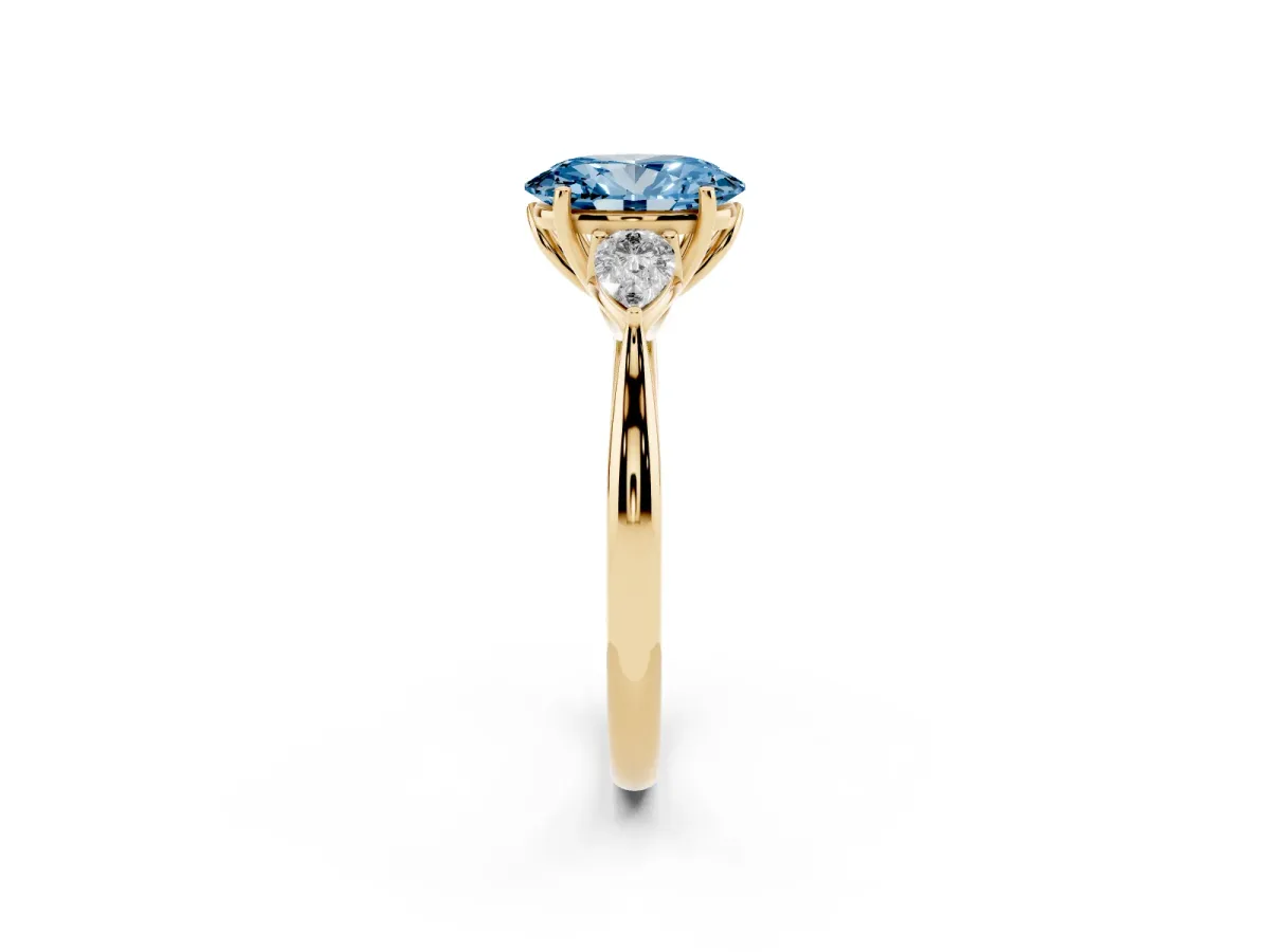 Fancy Blue Three-Stone Oval Cut Brilliant Diamond Solitaire Ring with Tapered Band and Four-Prong Setting Yellow gold