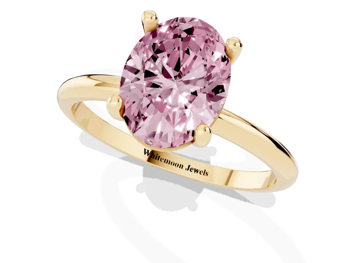 Fancy Pink Oval Cut Solitaire Diamond Ring with 4-Prong Setting on a Classic Band Yellow gold