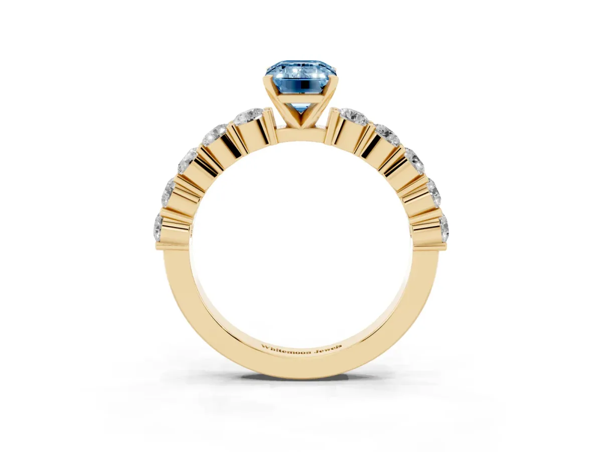 Fancy Blue Emerald Cut Diamond Solitaire Ring with Shared Prong Round Side Stones Yellow gold