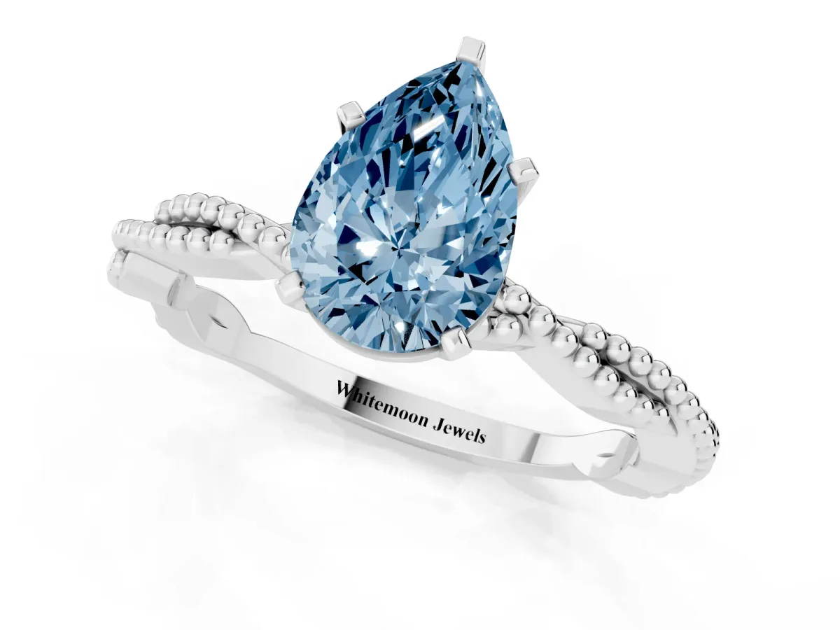 Fancy Blue Pear Cut Solitaire Twisted Band with Bead Prong Setting Platinum