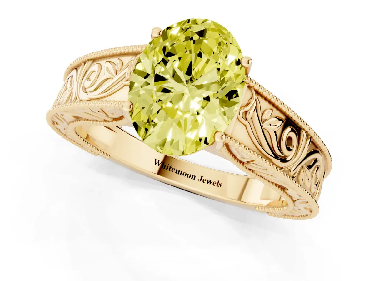 Fancy Yellow Oval Cut Diamond Solitaire Ring with Engraved Band and Four-Prong Setting Yellow gold