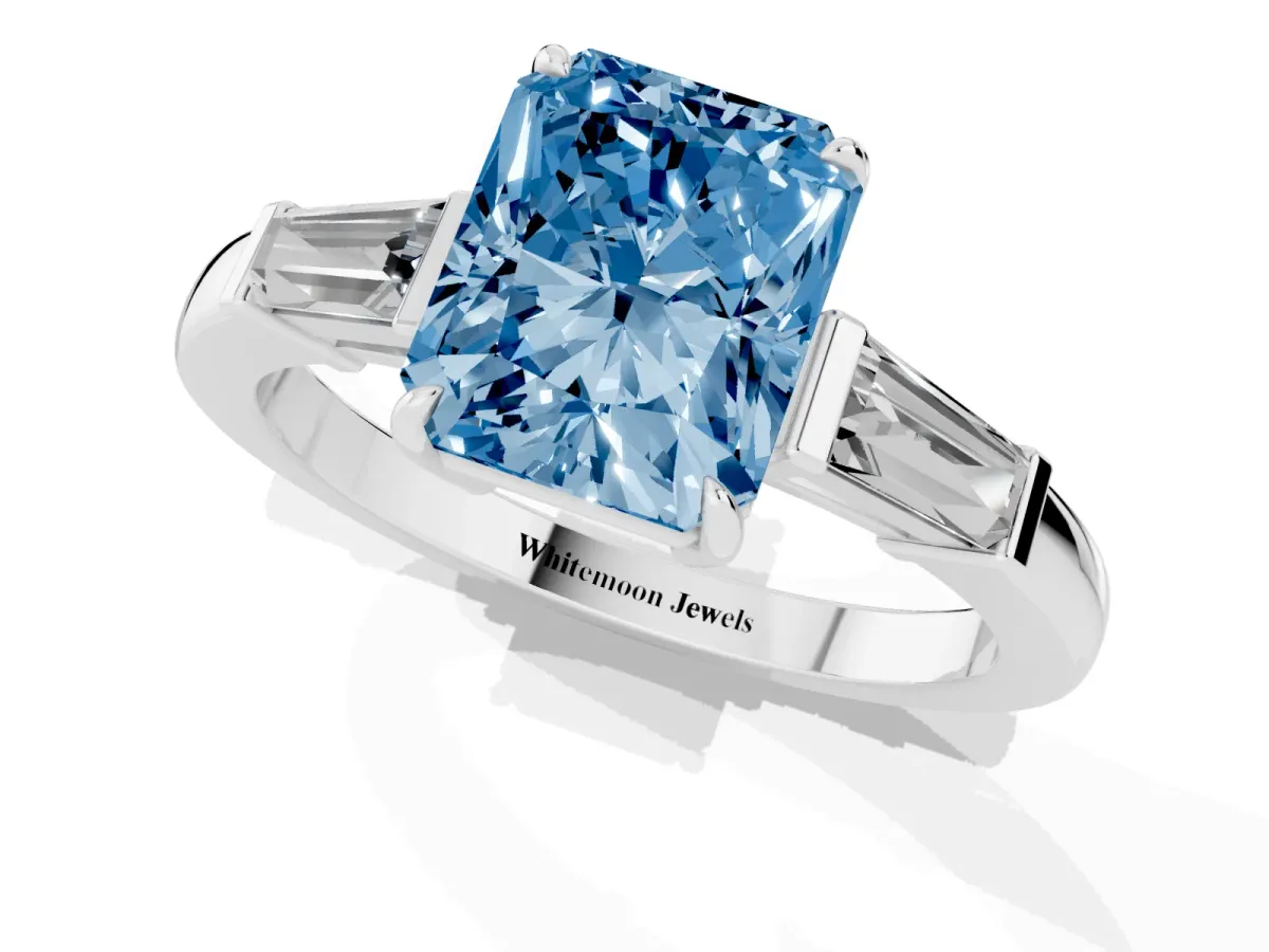 Fancy Blue Radiant Cut Diamond Three-Stone Ring with Tapered Baguette Side Stones and Prong Setting White gold