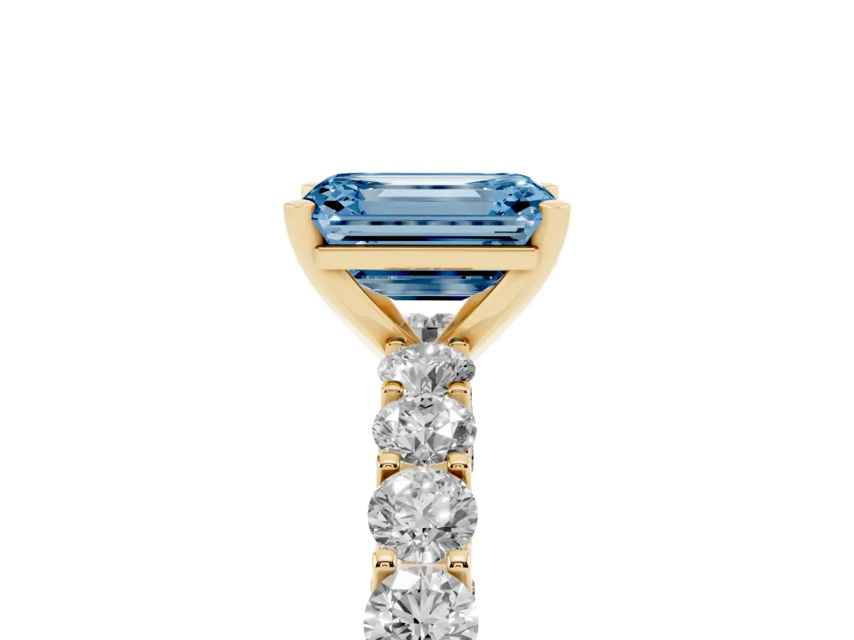 Fancy Blue Emerald Cut Diamond Solitaire Ring with Shared Prong Pavé Band and Four-Prong Setting Yellow gold