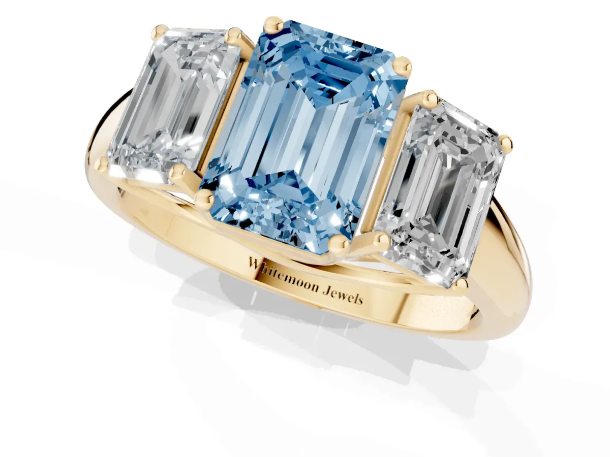 Fancy Blue Three-Stone Emerald Cut Diamond Engagement Ring with Prong Setting Yellow gold