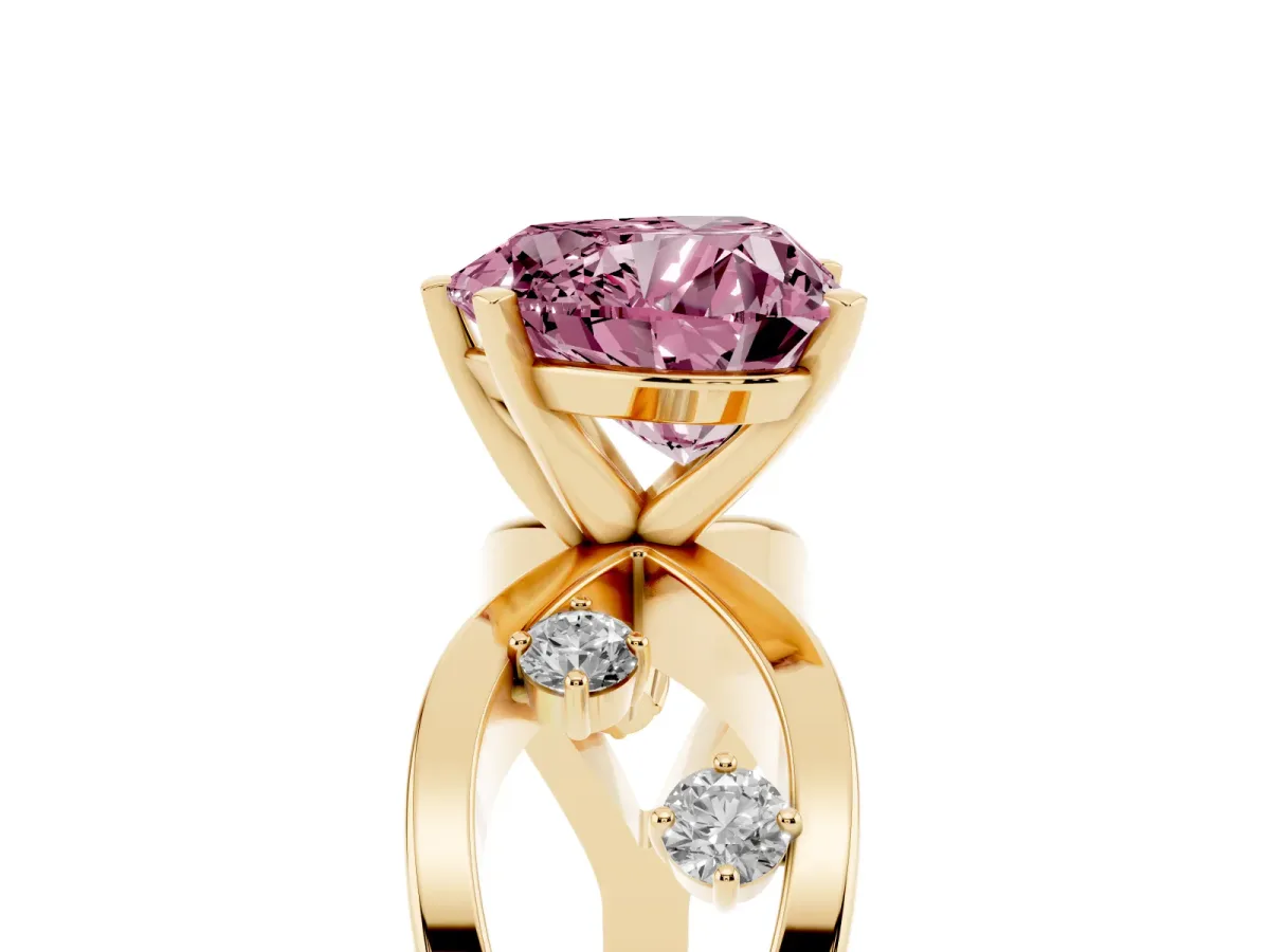 Fancy Pink Heart Cut Cut Solitaire Diamond with Side Stones on Criss-Cross Band and Four-Prong Setting Yellow gold