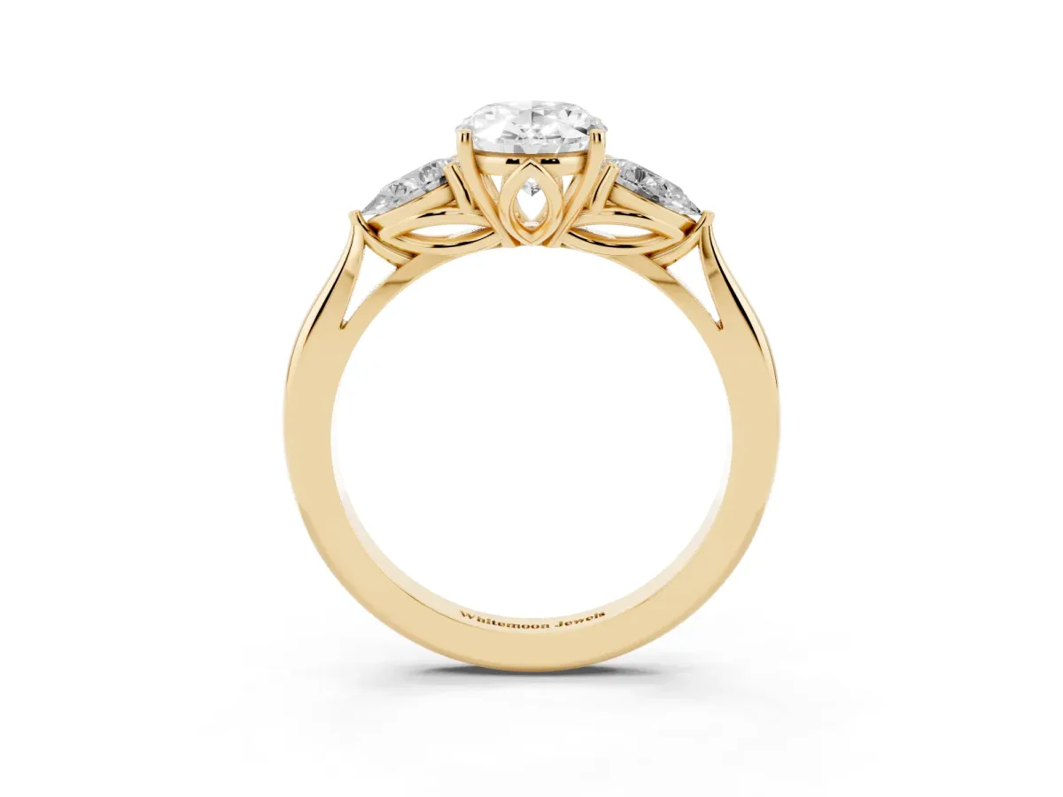 Three-Stone Oval Cut Diamond Ring with Pear Side Stones in Four-Prong Setting Yellow gold