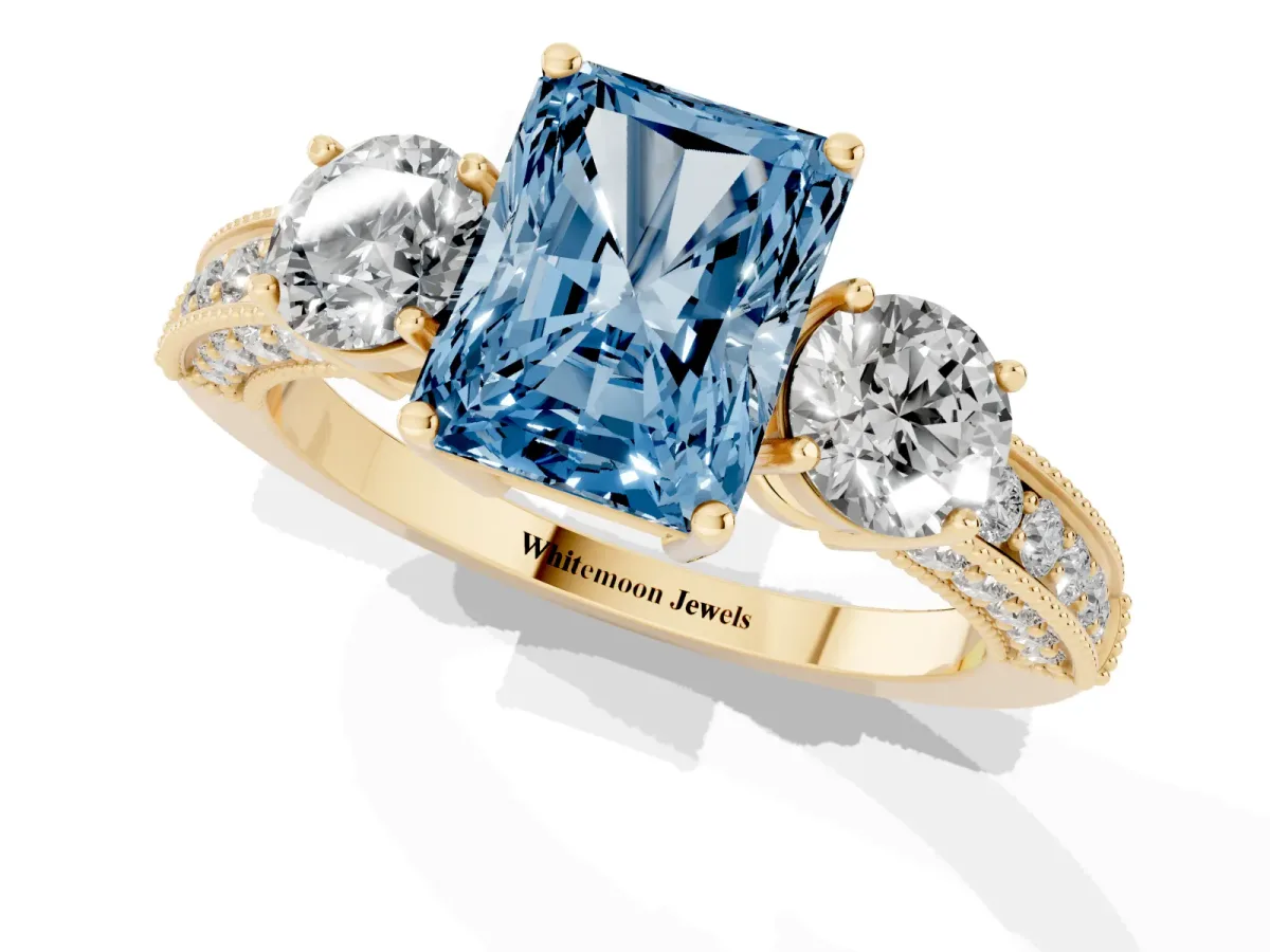 Fancy Blue Radiant Cut Three-Stone Diamond Ring with Pavé Band and Four-Prong Setting Yellow gold