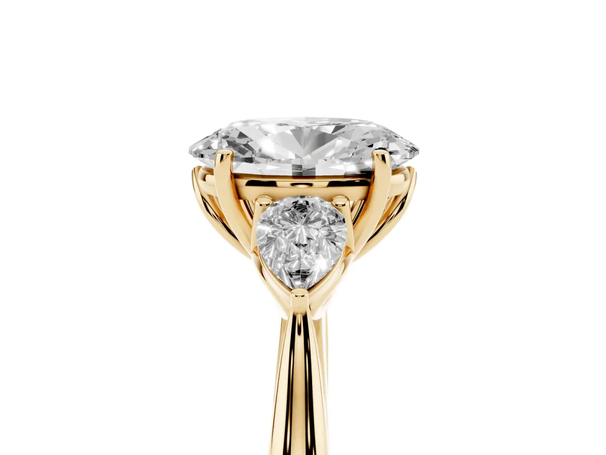 Three-Stone Oval Cut Diamond Ring with Pear Side Stones in Four-Prong Setting Yellow gold